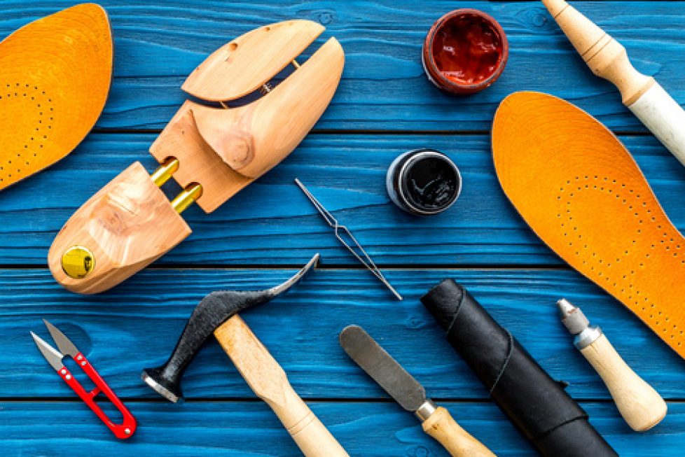 Instruments and materials for make shoes. Shoemaker's work desk.